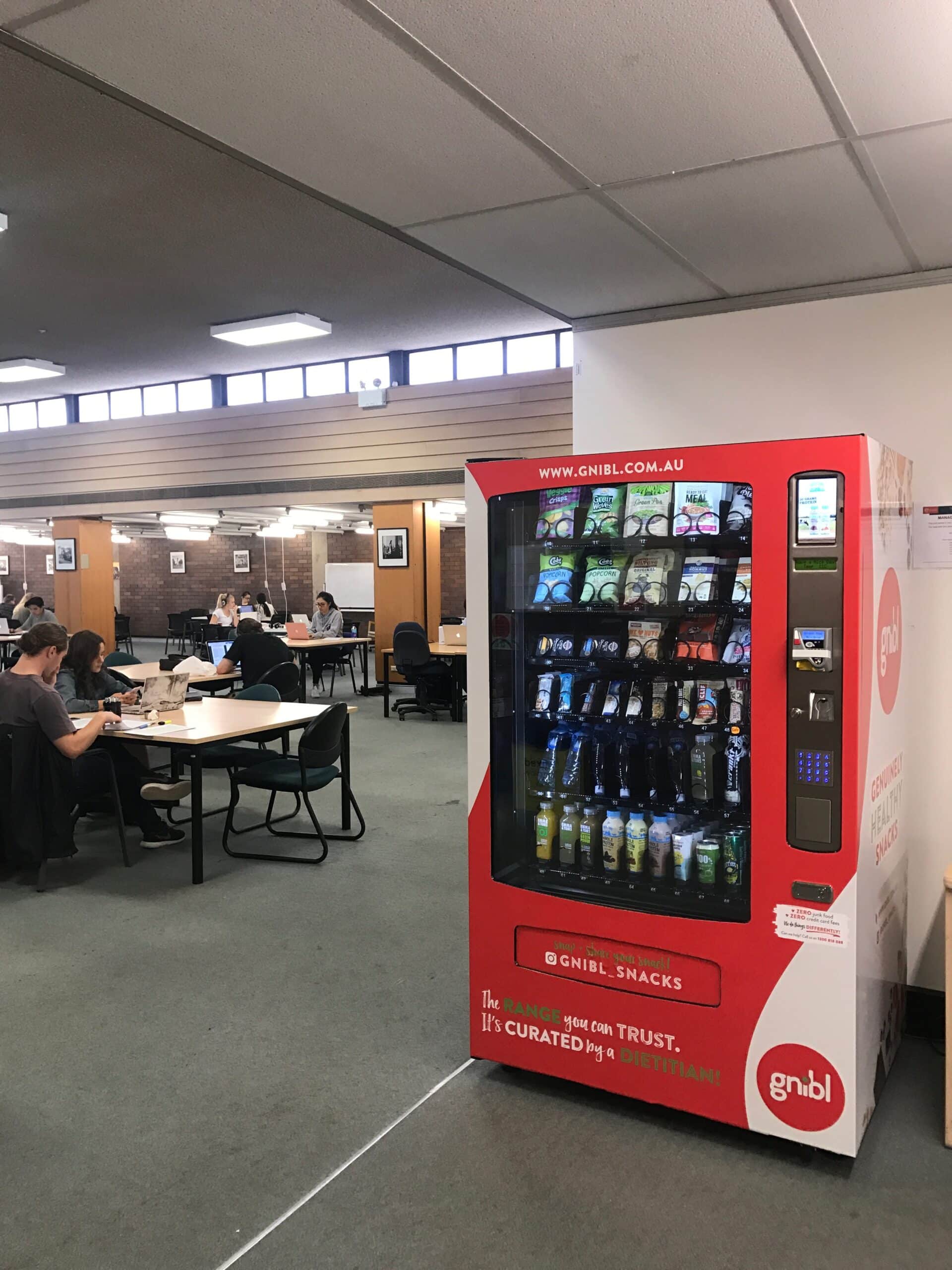 a fully stocked gnibl vending machine in an office
