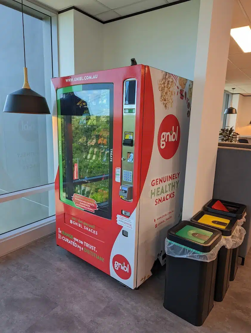 a fully stocked gnibl vending machine in an office