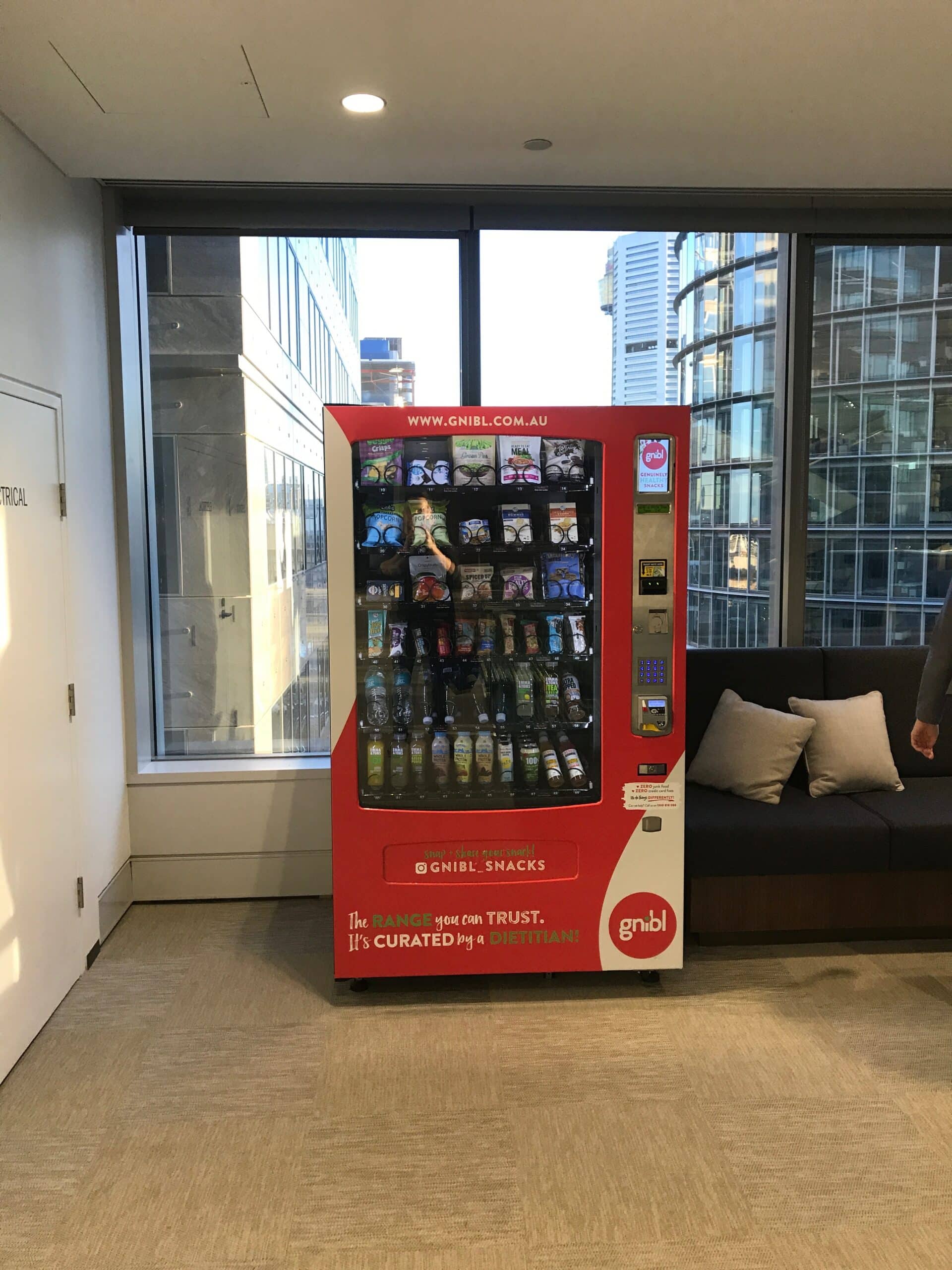 Fully stocked Gnibl vending machine in an office setting in Sydney.
