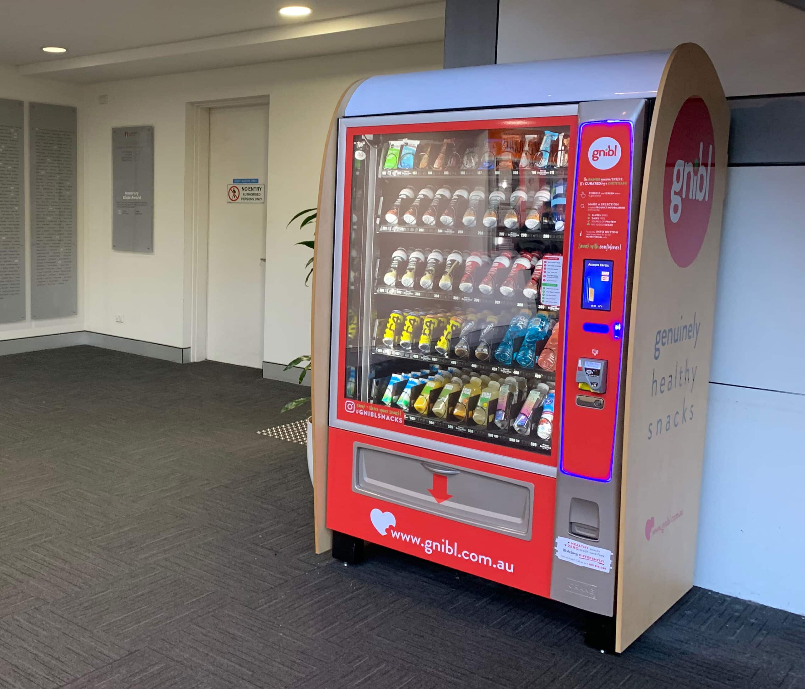 A Gnibl combination vending machine stocked with healthy snack and drink options.